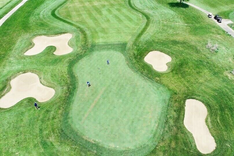 Aerial view of a golf course green.
